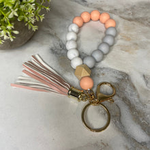 Load image into Gallery viewer, Silicone Bracelet Keychain with Wood Bead &amp; Tassel - Orange Cream
