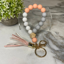Load image into Gallery viewer, Silicone Bracelet Keychain with Wood Bead &amp; Tassel - Orange Cream

